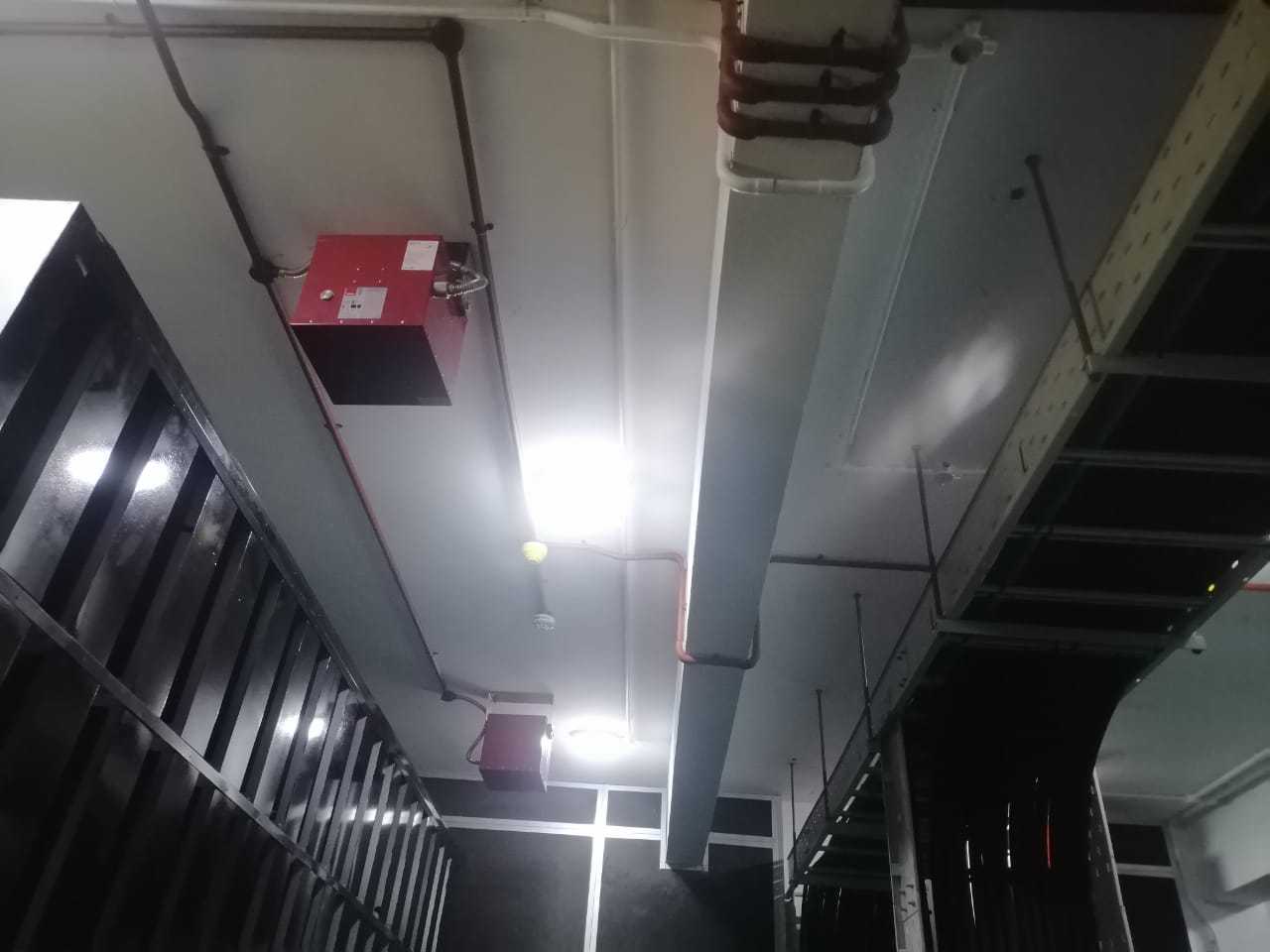 Fire suppression system unit installed near cable tray and air duct