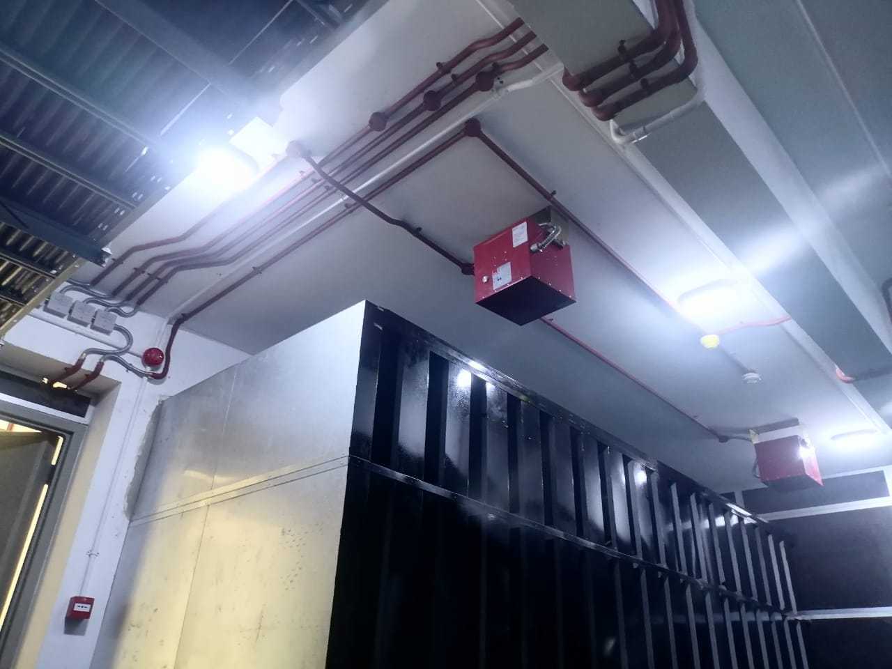 Additional fire suppression unit with visible piping and protected equipment area