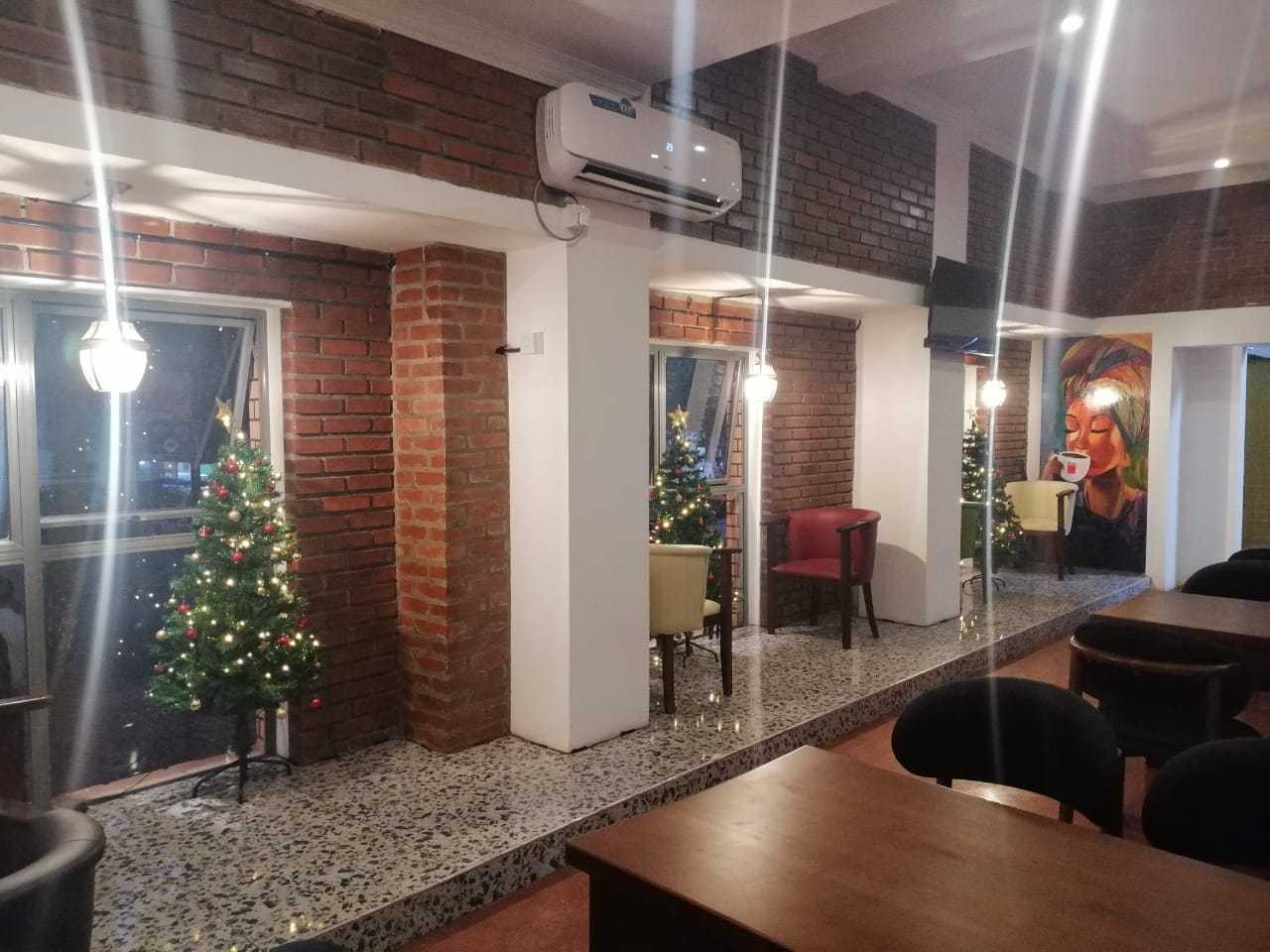 Trillium Express interior seating area with brick walls, pendant lighting and Christmas decorations