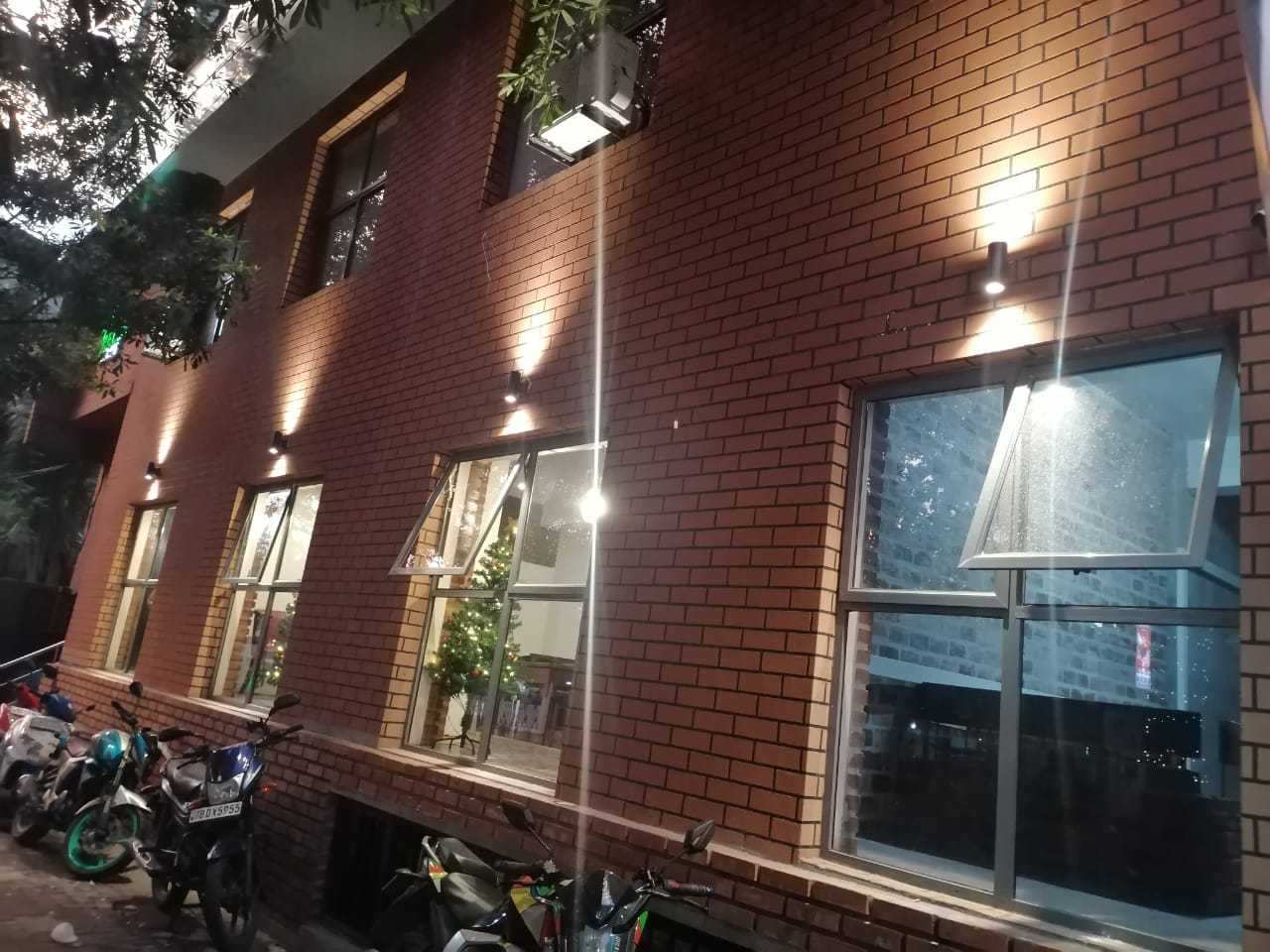 Trillium Express brick facade with exterior wall lighting and windows